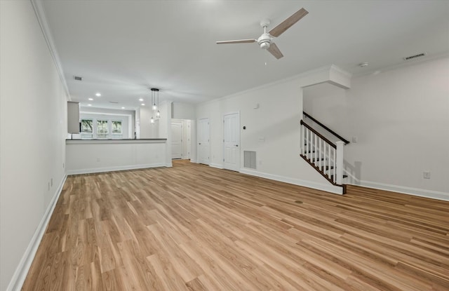 unfurnished living room featuring crown molding, visible vents, stairway, and light wood-type flooring