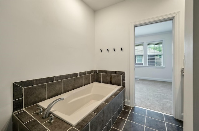 full bathroom featuring tile patterned flooring, baseboards, and a garden tub