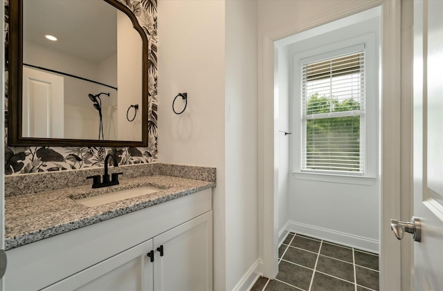 bathroom featuring vanity, baseboards, and tile patterned floors