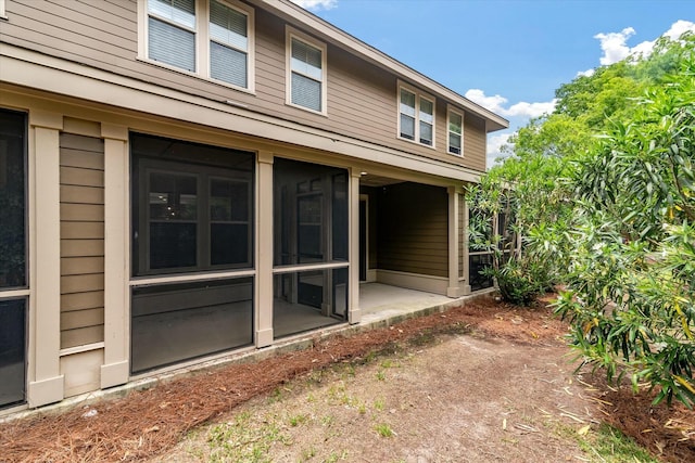 rear view of house with a sunroom