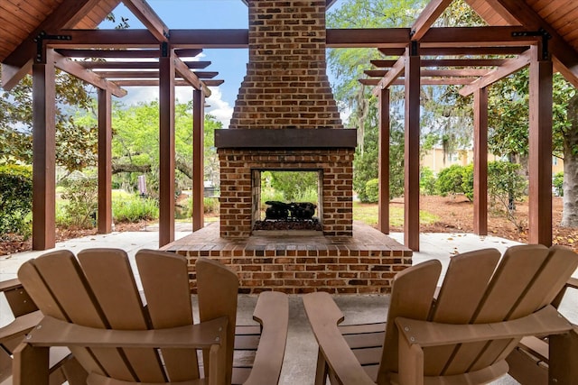 view of patio featuring a brick fireplace and a pergola