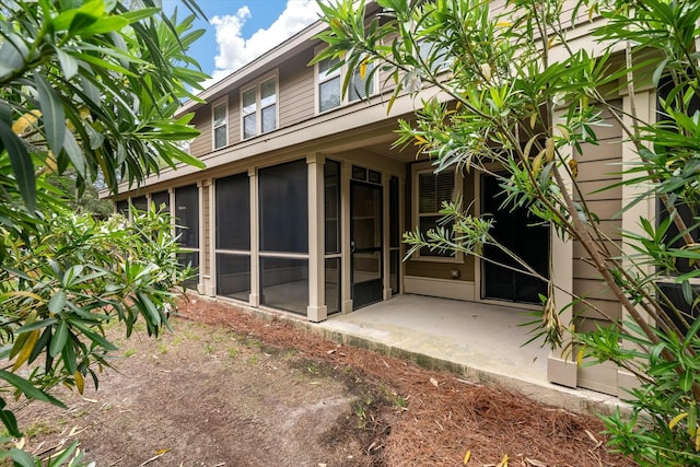 back of house featuring a sunroom