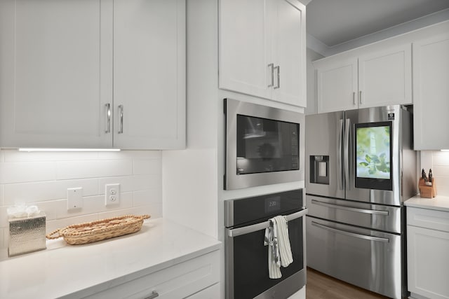 3705 Sandy Gate Ln, Mount Pleasant, SC 29466 - kitchen featuring appliances with stainless steel finishes, tasteful backsplash, light countertops, white cabinetry, and dark wood-style floors