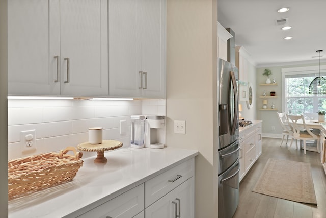 3705 Sandy Gate Ln, Mount Pleasant, SC 29466 - kitchen with appliances with stainless steel finishes, tasteful backsplash, light wood-style floors, white cabinetry, and recessed lighting