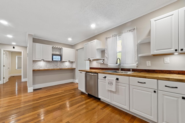 kitchen featuring light hardwood / wood-style floors, dishwasher, and butcher block counters