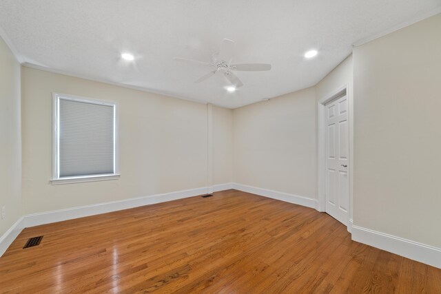 empty room featuring ceiling fan and hardwood / wood-style flooring