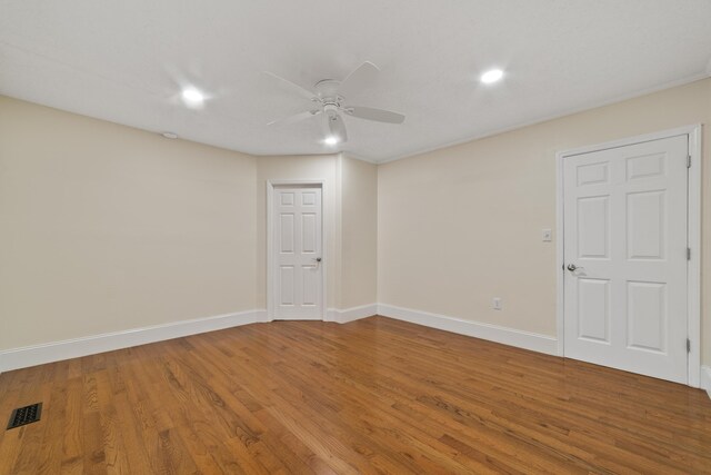 spare room with ceiling fan and hardwood / wood-style flooring