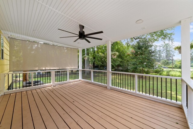 deck with a yard and ceiling fan