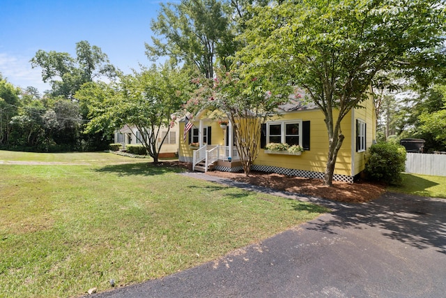 obstructed view of property featuring a front lawn and covered porch