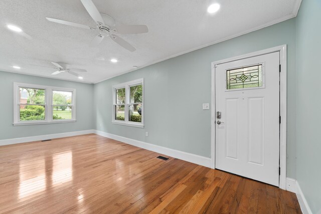 entrance foyer with ceiling fan, hardwood / wood-style flooring, and a textured ceiling