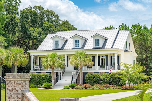 cape cod-style house with a porch and a front yard