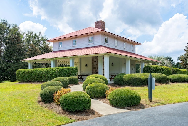 country-style home featuring a porch and a front yard