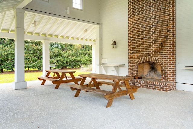 view of patio / terrace featuring an outdoor brick fireplace