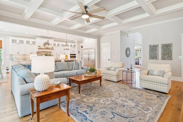 living room with beam ceiling, light wood-type flooring, ceiling fan, and coffered ceiling