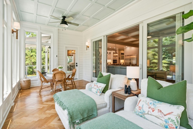 sunroom featuring beam ceiling, ceiling fan, and coffered ceiling