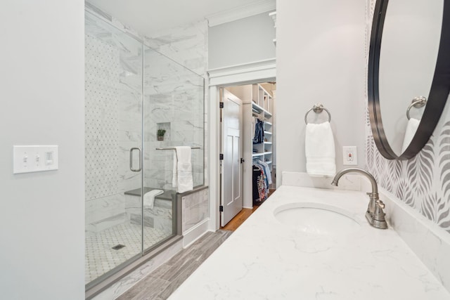 bathroom featuring vanity, wood-type flooring, and a shower with door