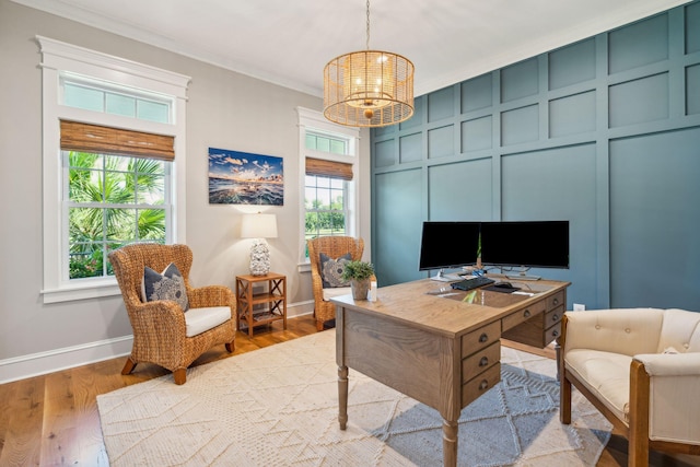 office with ornamental molding, light hardwood / wood-style flooring, and a notable chandelier