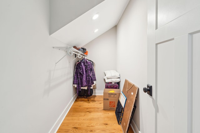 spacious closet featuring hardwood / wood-style floors and lofted ceiling