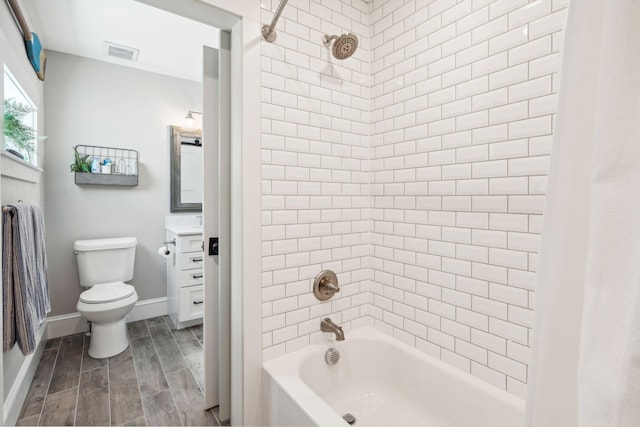 full bathroom featuring shower / tub combo, vanity, and toilet