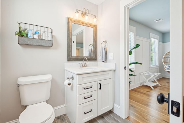 bathroom featuring vanity, toilet, and wood-type flooring