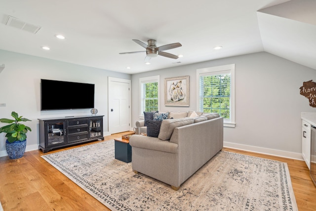 living room featuring a wealth of natural light, ceiling fan, light hardwood / wood-style floors, and lofted ceiling