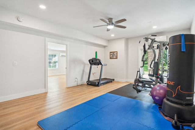 exercise area with hardwood / wood-style flooring and ceiling fan