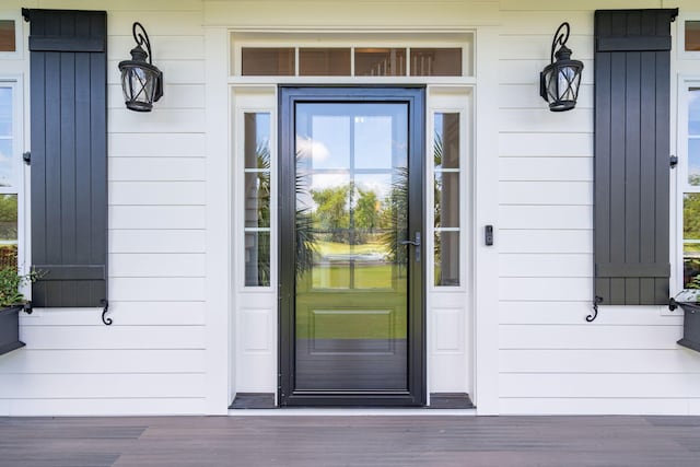 view of exterior entry featuring a porch