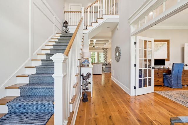 entrance foyer with hardwood / wood-style floors and ornamental molding