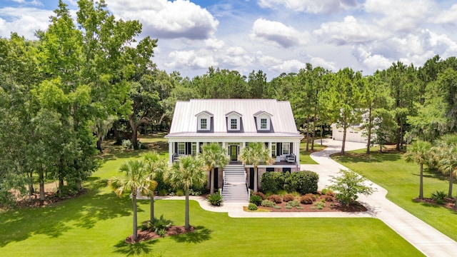 view of front of home with covered porch and a front yard