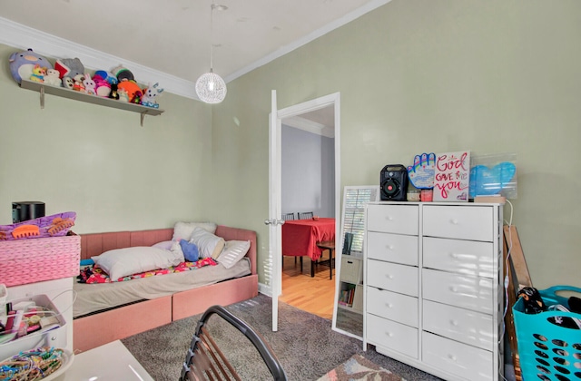 bedroom featuring hardwood / wood-style floors and crown molding
