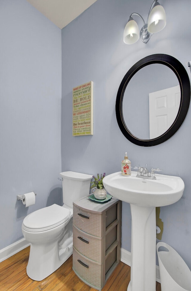 bathroom with sink, toilet, and hardwood / wood-style flooring