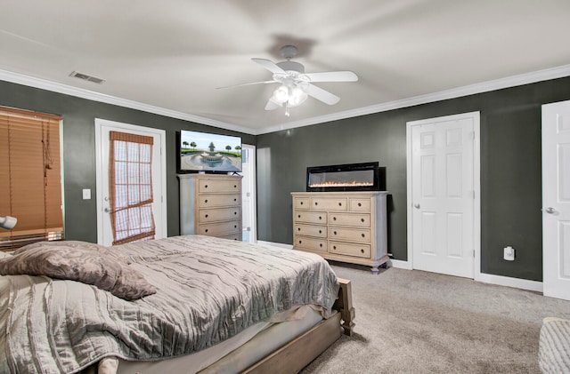 carpeted bedroom with ceiling fan and ornamental molding