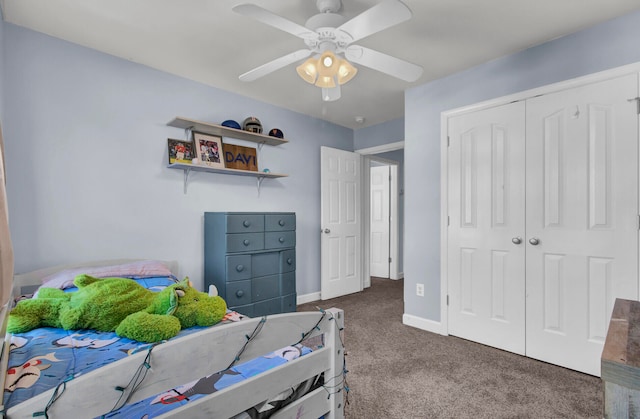 bedroom with dark colored carpet, ceiling fan, and a closet