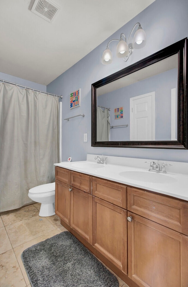 bathroom with tile patterned floors, vanity, and toilet