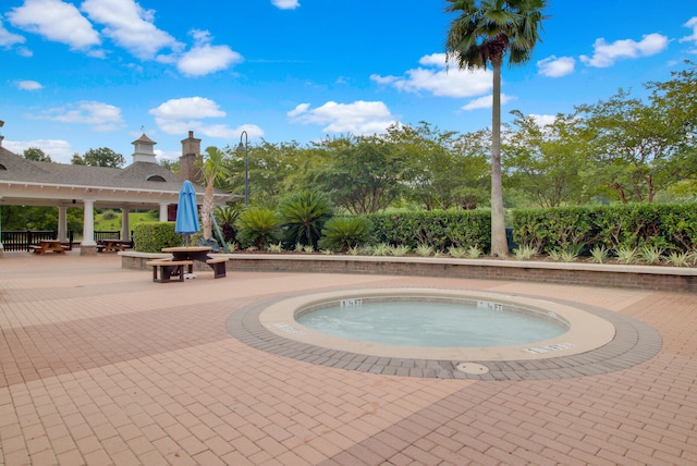view of pool featuring an in ground hot tub and a patio area