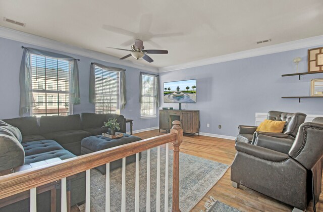 living room featuring ceiling fan, light hardwood / wood-style flooring, and ornamental molding