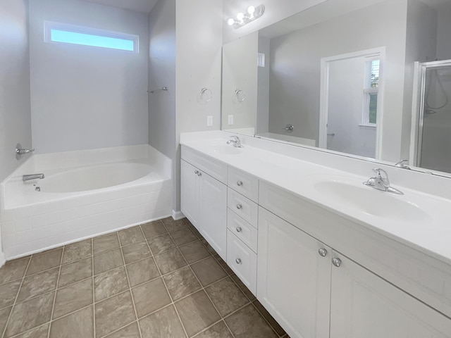 bathroom with vanity, a washtub, and tile patterned floors