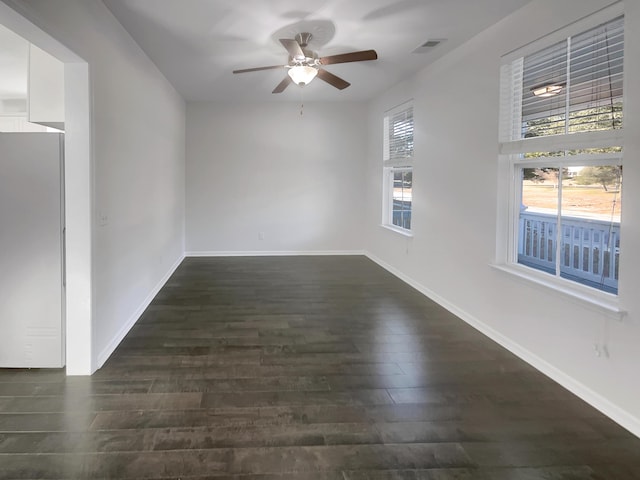 spare room featuring dark hardwood / wood-style floors and ceiling fan