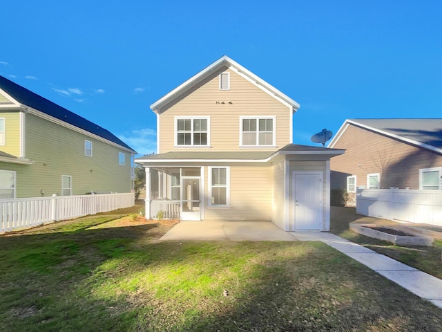 back of house with a patio, a sunroom, and a yard