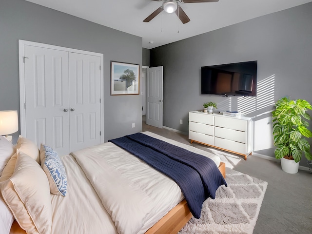 bedroom with light colored carpet, a closet, and ceiling fan