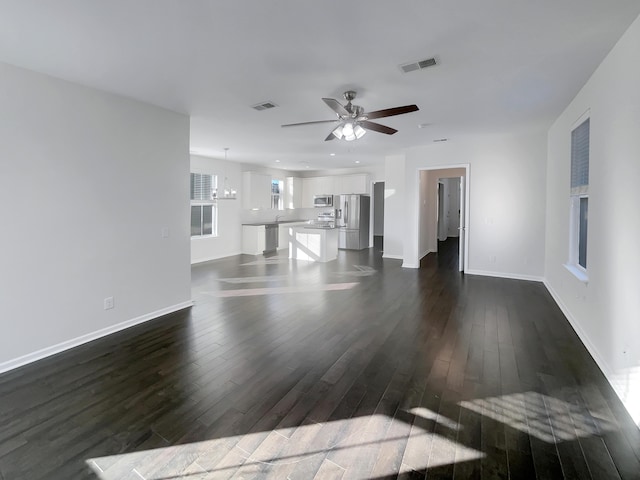 unfurnished living room featuring ceiling fan and dark hardwood / wood-style floors