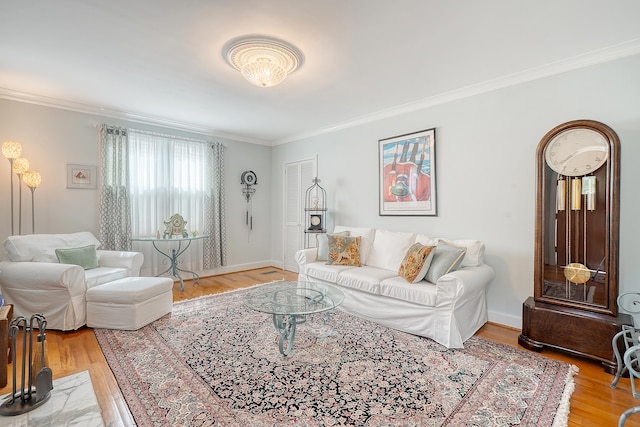 living room with ornamental molding, baseboards, and wood finished floors