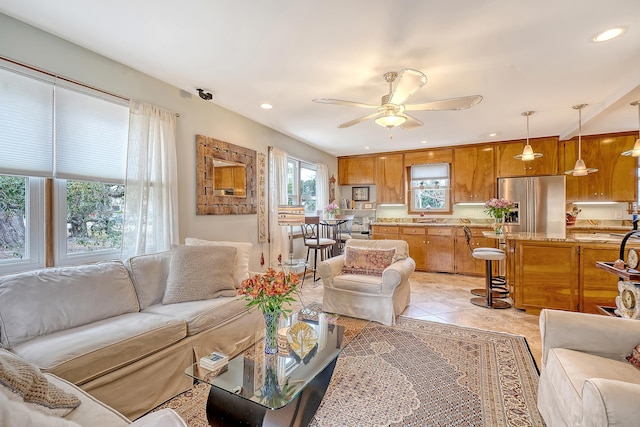 living area featuring recessed lighting, a ceiling fan, and light tile patterned flooring