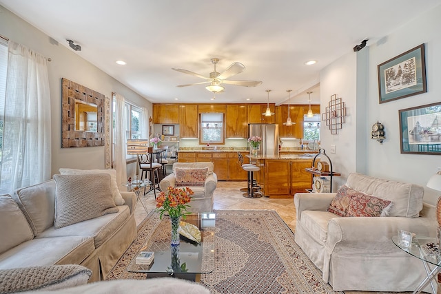 living area featuring a ceiling fan and recessed lighting