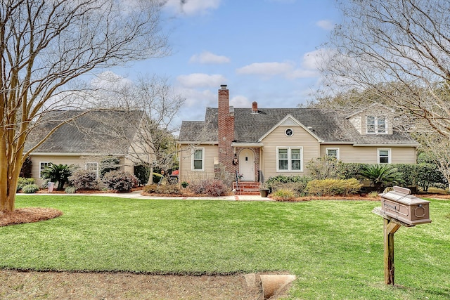 view of front of home featuring a chimney and a front lawn