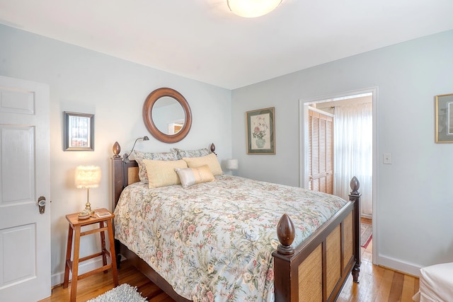 bedroom featuring baseboards and wood finished floors