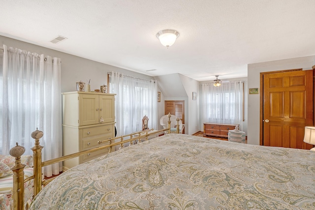 bedroom featuring multiple windows and visible vents