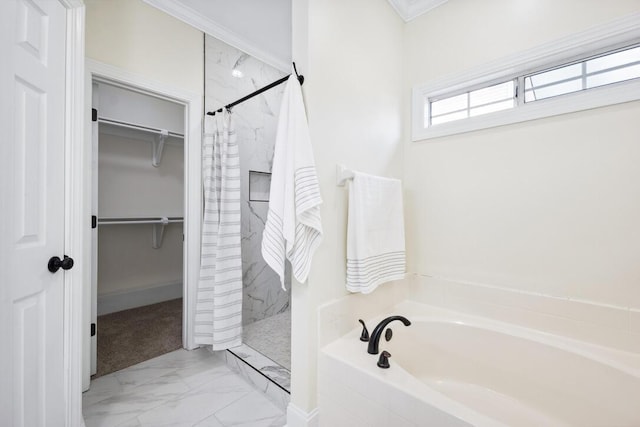 bathroom with marble finish floor, a bath, a walk in closet, and a shower stall