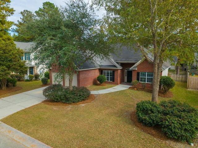 view of front of home featuring driveway, an attached garage, fence, brick siding, and a front lawn
