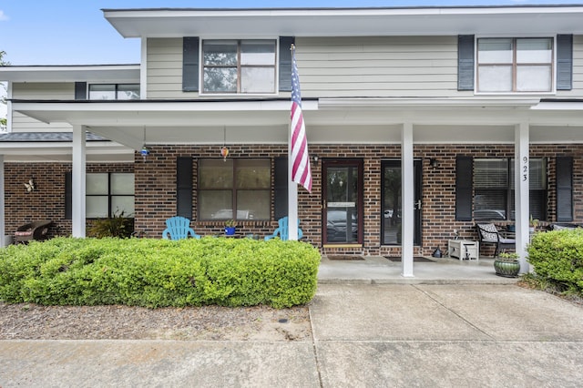 property entrance featuring brick siding